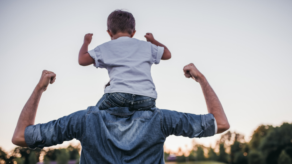 kid on dad's shoulders