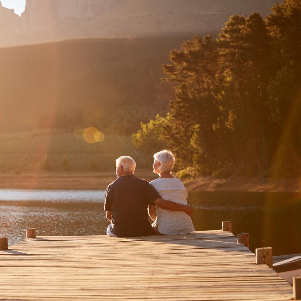 Retirement Planning Couple Sitting On A Dock